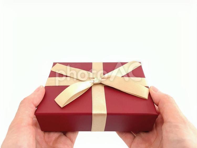 Female hand giving a present, present, give a present, women's hands, JPG