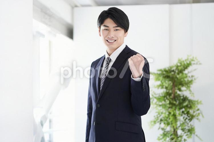 Japanese male businessman doing guts pose looking at the camera, male, businessman, a smile, JPG