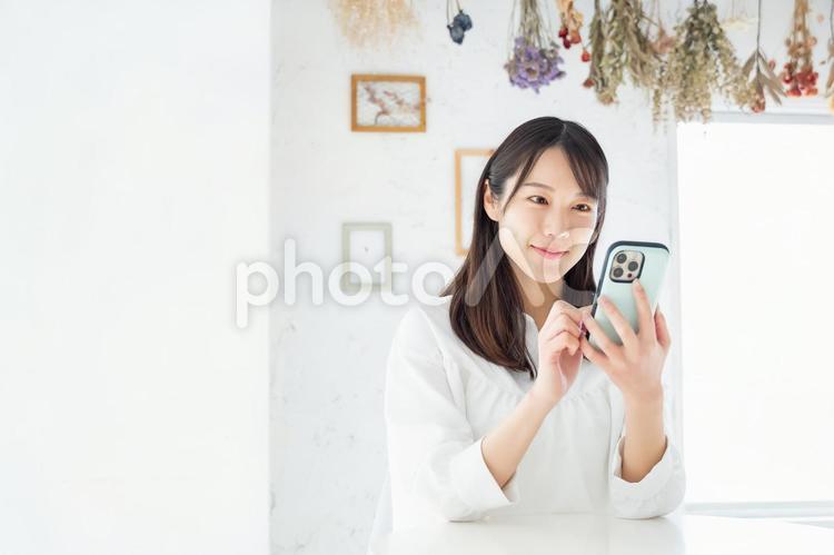 Young woman operating a smartphone, female, a smile, smartphone, JPG