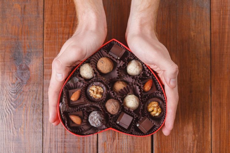 free chocolate images - hands holding a heart-shaped box of chocolate photoAC